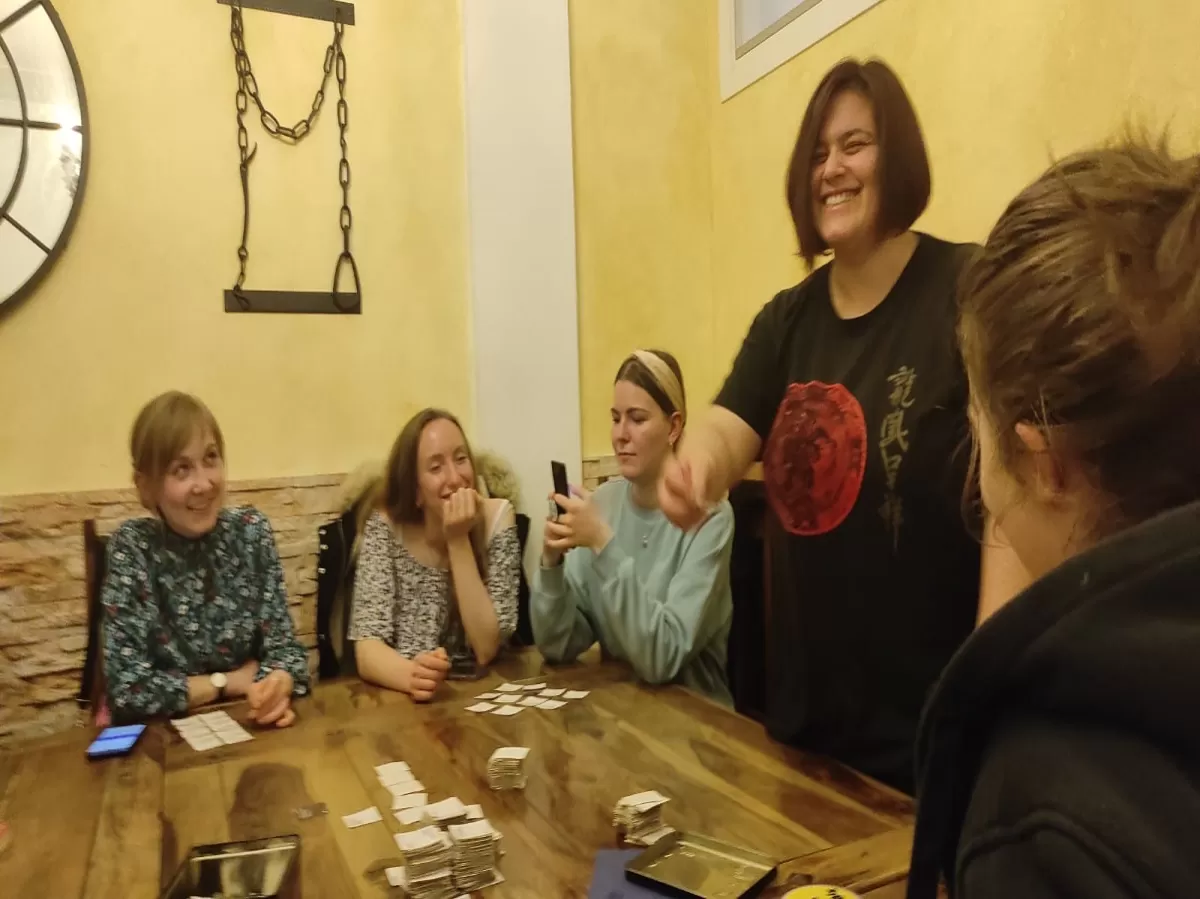 The participants at the table playing one of the board games