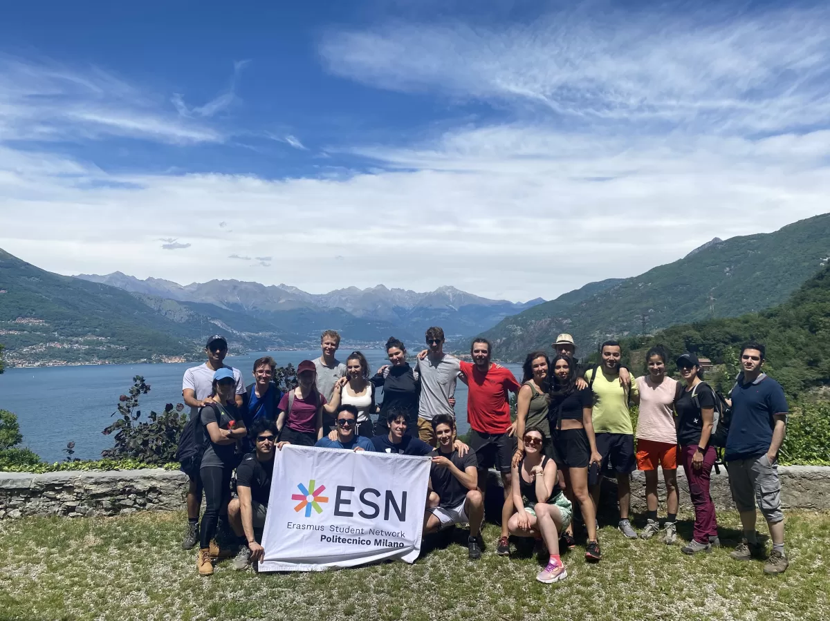 ESNers and international students holding the ESN flag in front of the Como lake