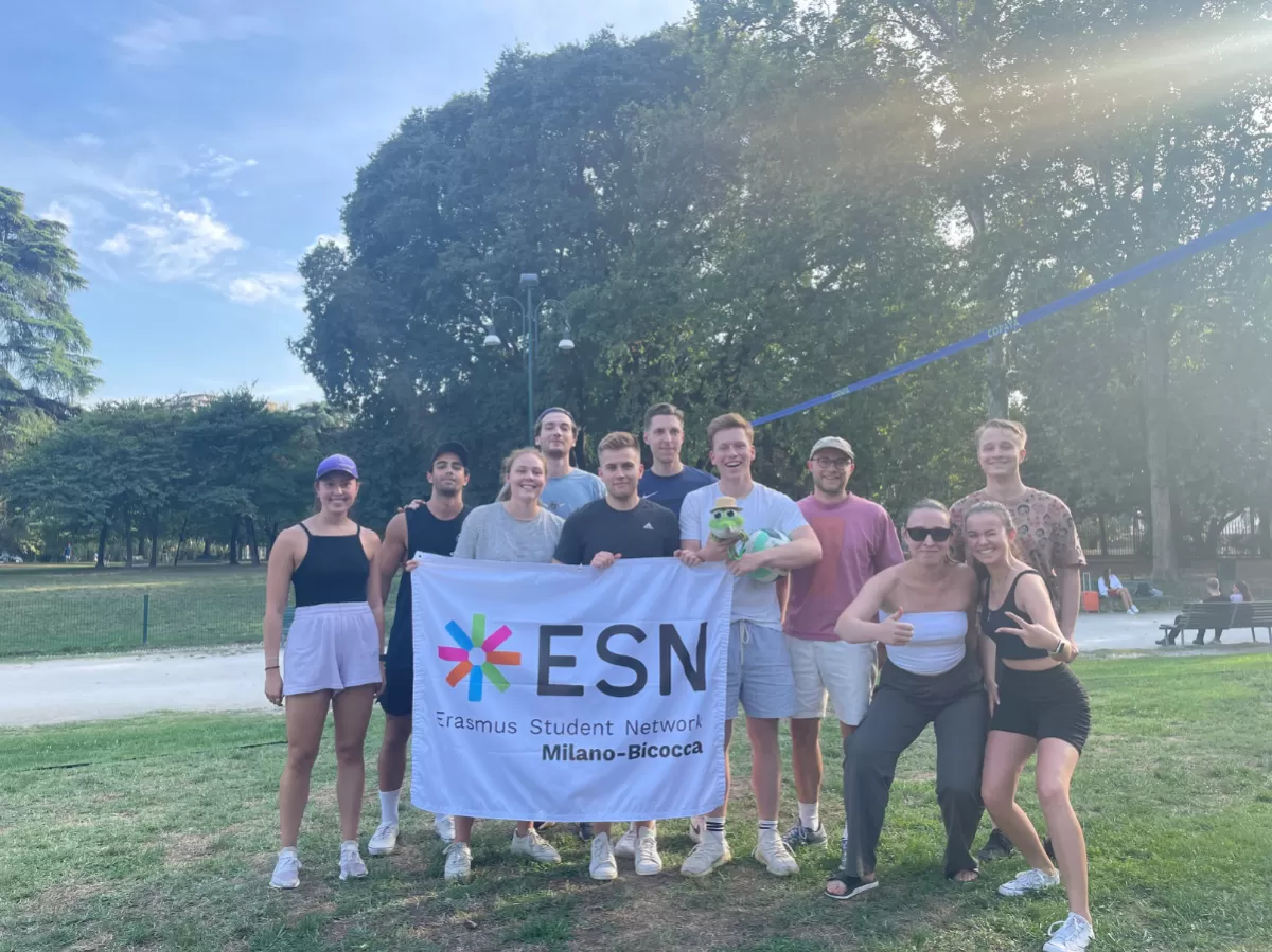 Group of international students with the flag of ESN Milano-Bicocca