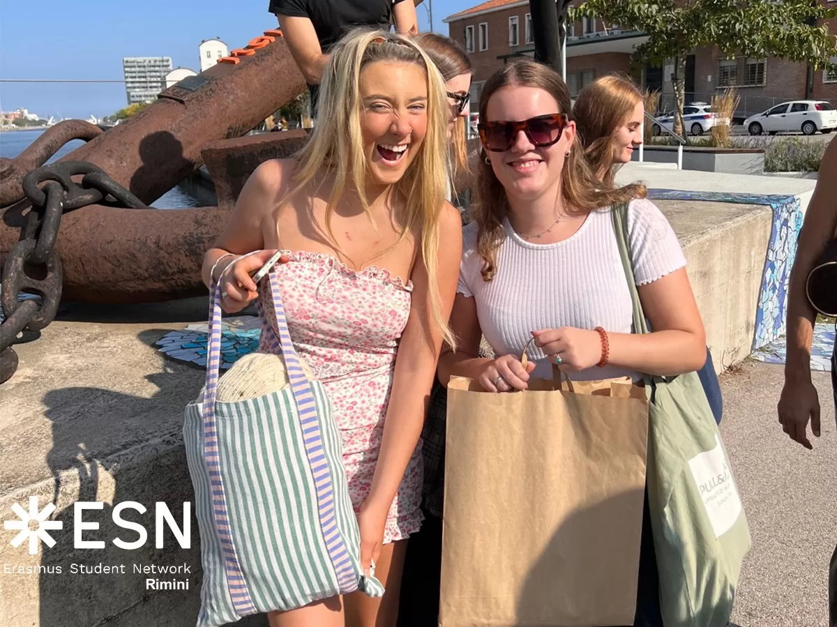 Erasmus girls showing proudly their shopping bags full of clothes and vintage objects