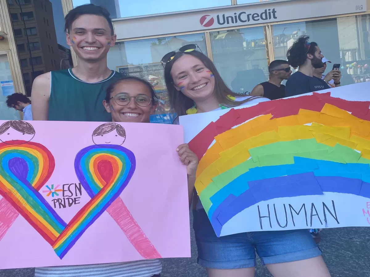 International students holding the colorful pride signs they made