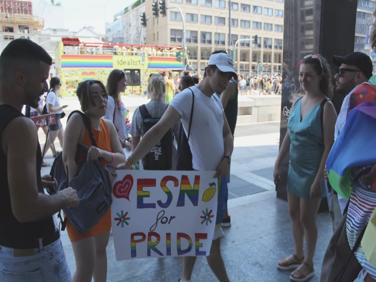 International students holding the colorful pride sign they made