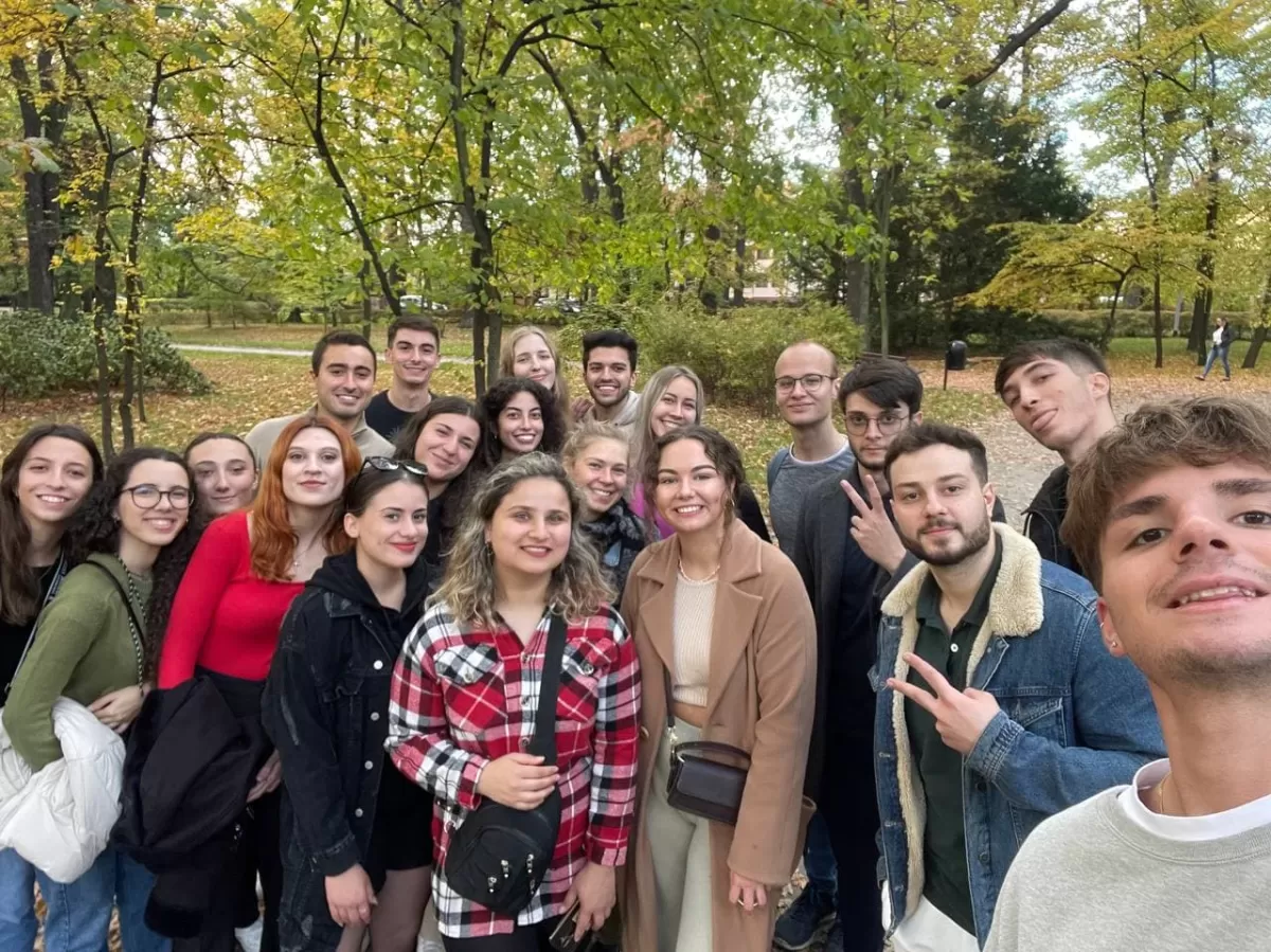 A selfie of a group of international students in the park.