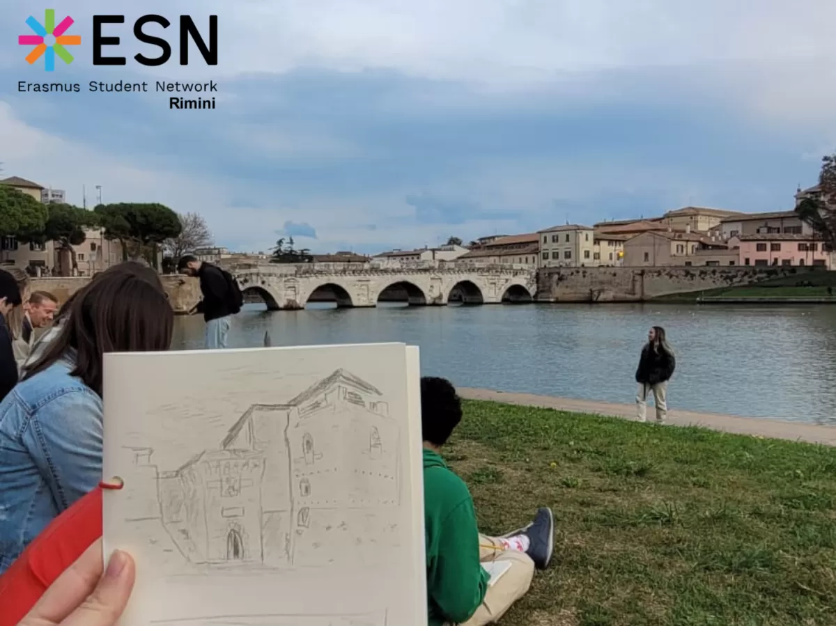 An erasmus showing his Castel Sismondo drawing in front of the Tiberio Bridge