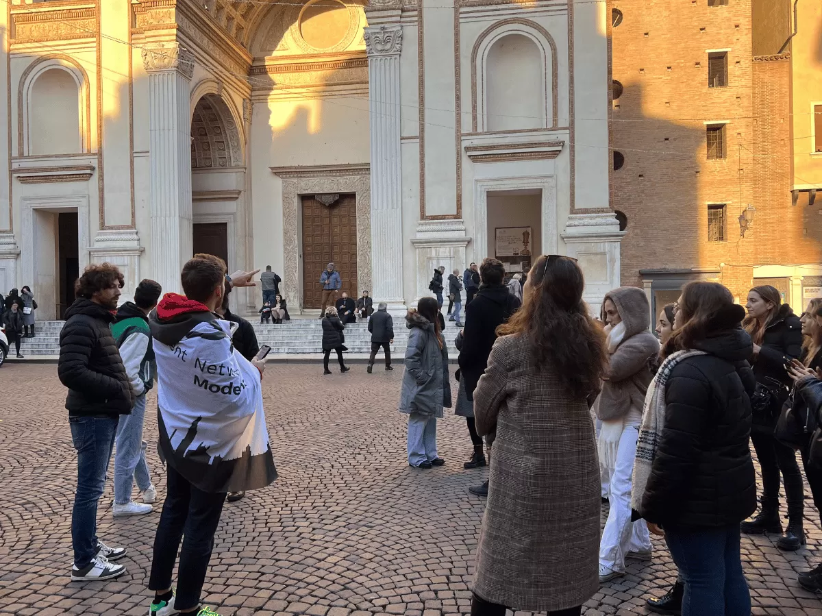 International students listening to the guide in front od sant'Andrea Basilica