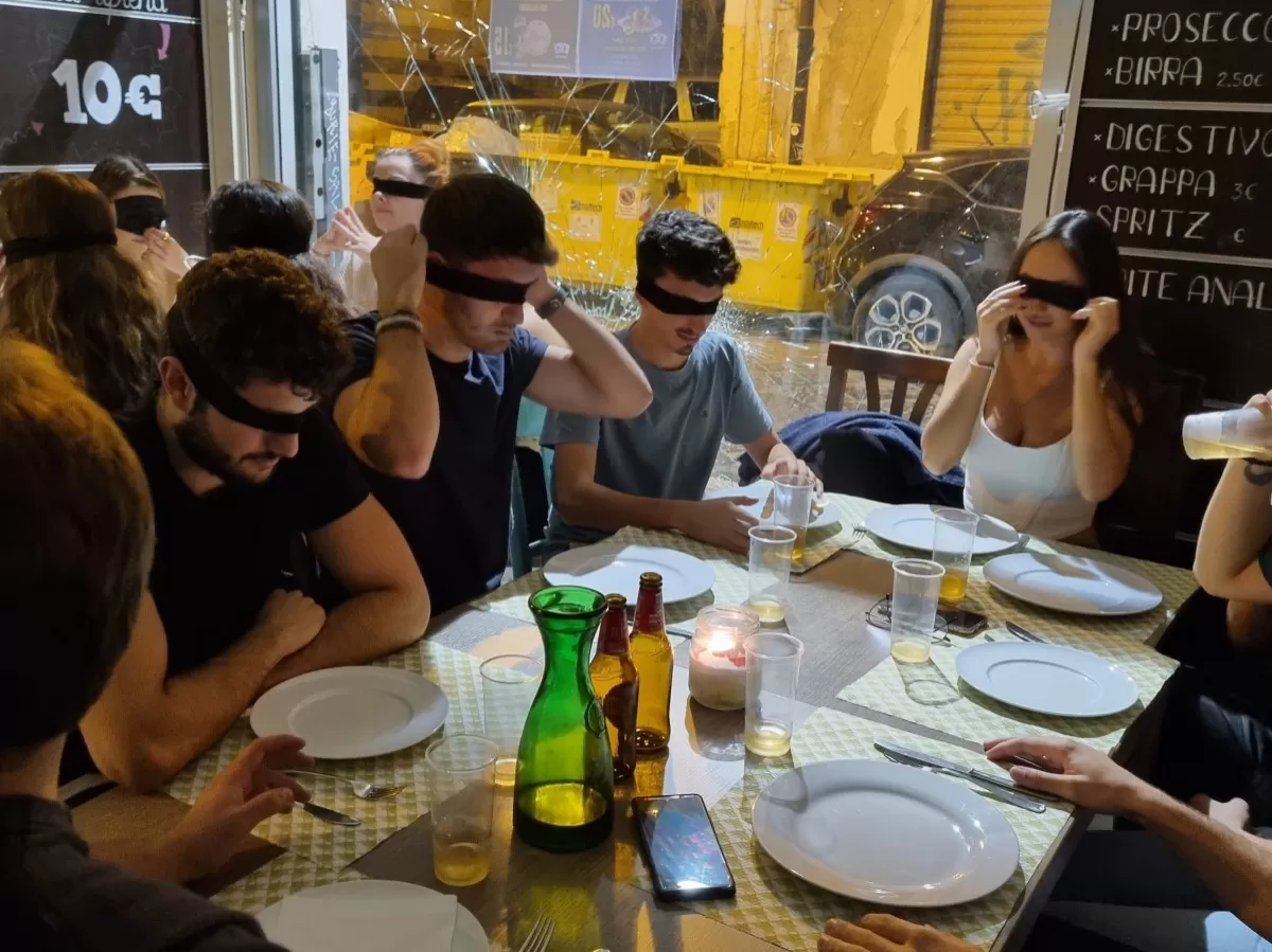 Guys having dinner blindfolded.