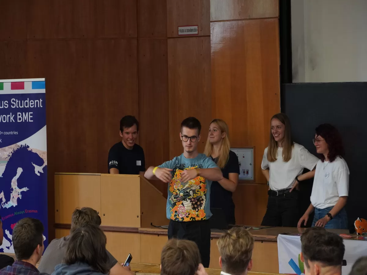 a boy signaling with both hands in front of the ESN BME board members