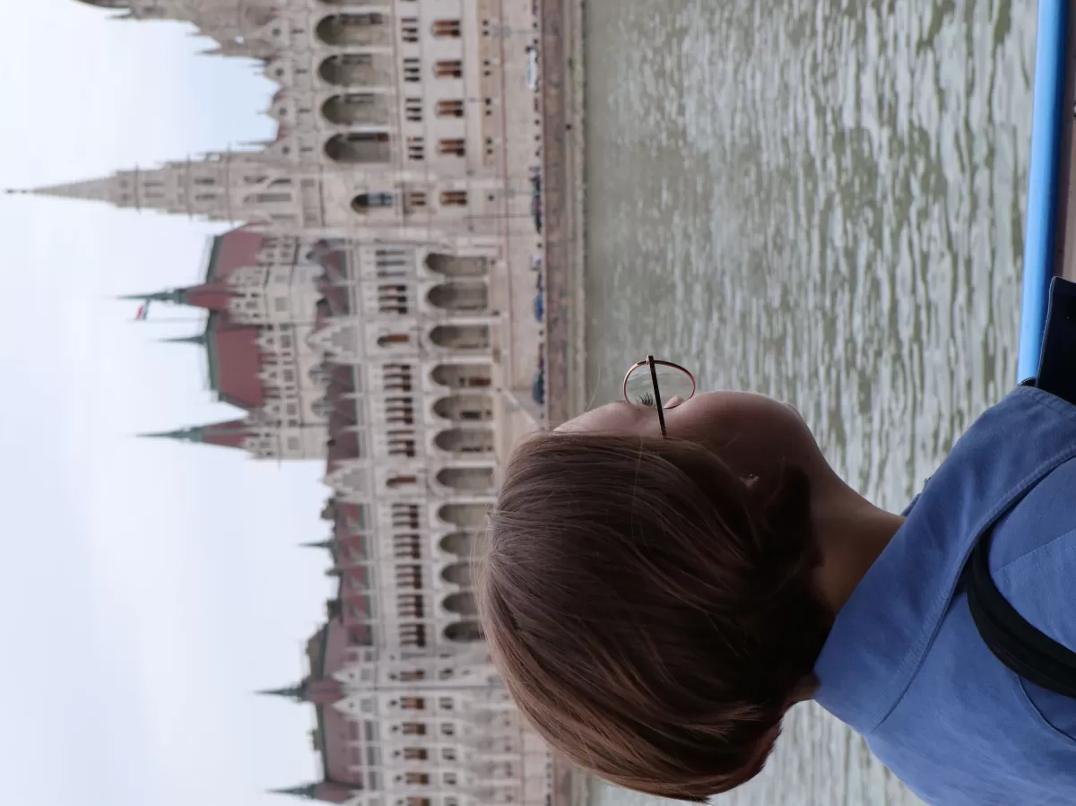 girl looking at the Hungarian parliament building from a ship