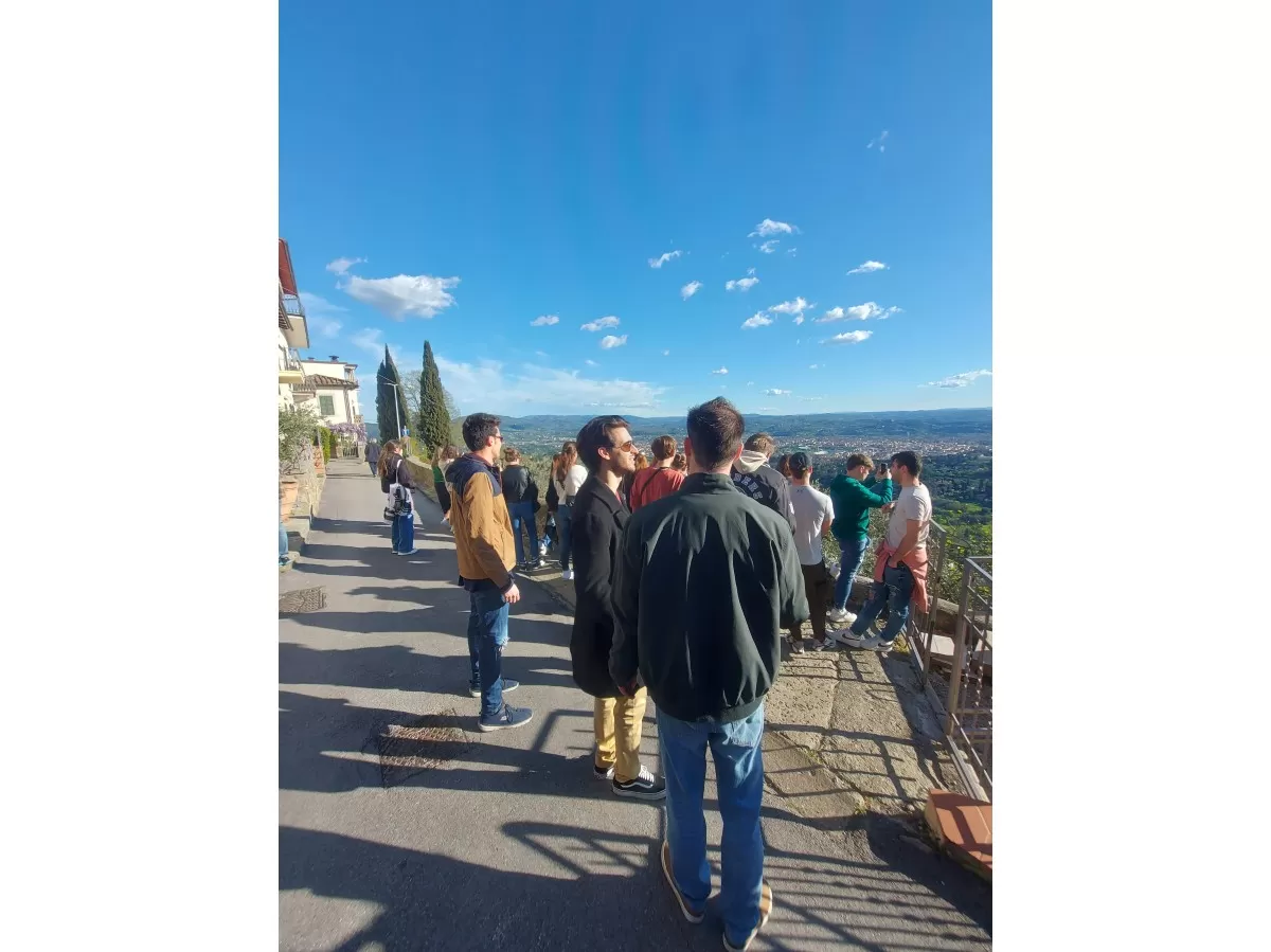 Panorama over Florence and international students interacting with esners