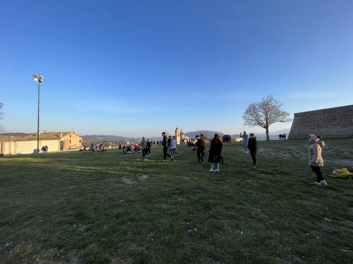 a wide picture of international students and volunteers playing volleyball