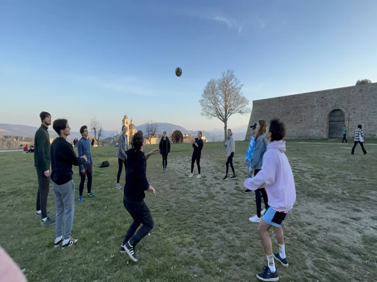 group of international students and volunteers playing volleyball
