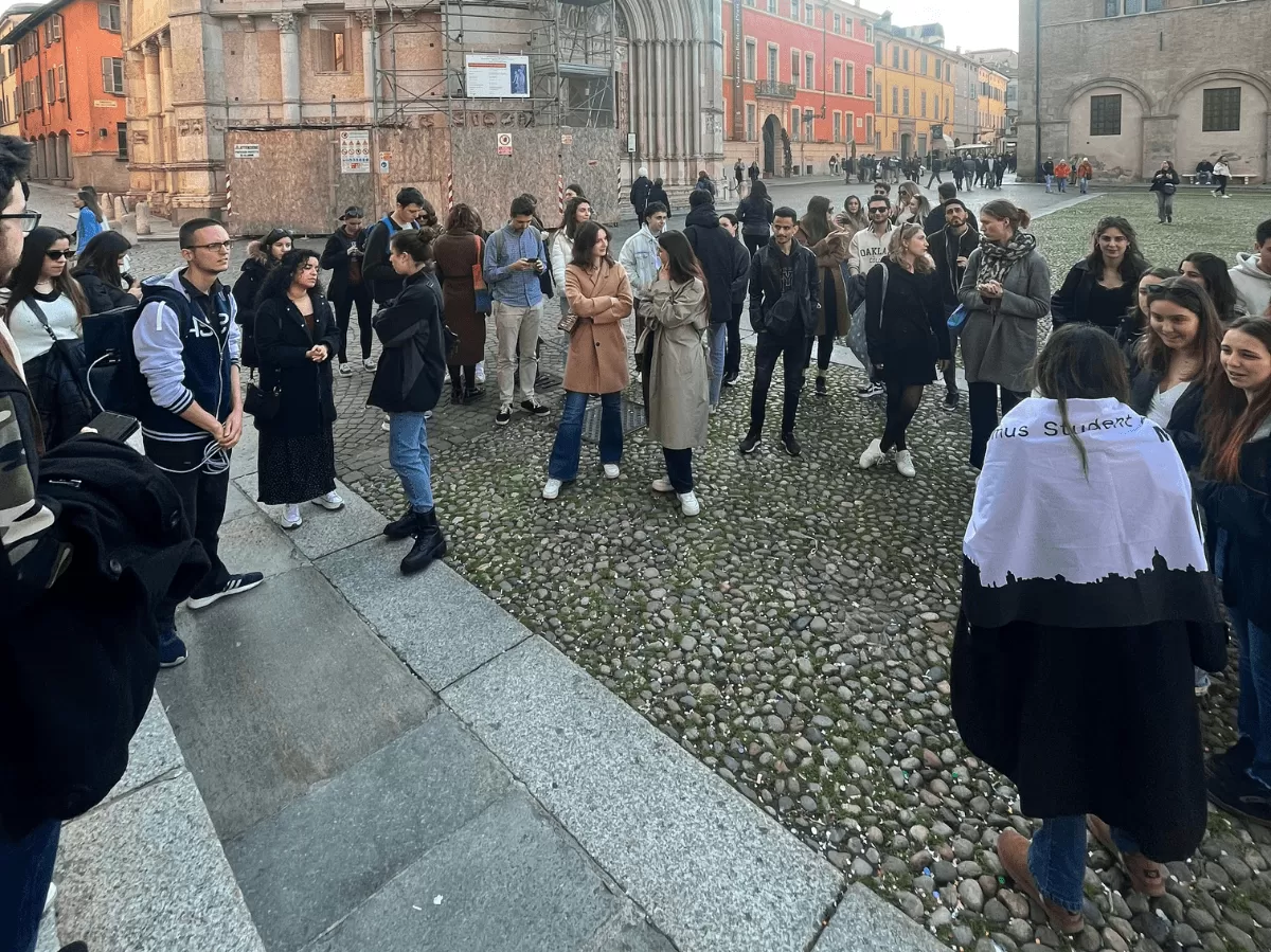 Group of international student in front of Santa Maria Assunta Cathedral, Parma