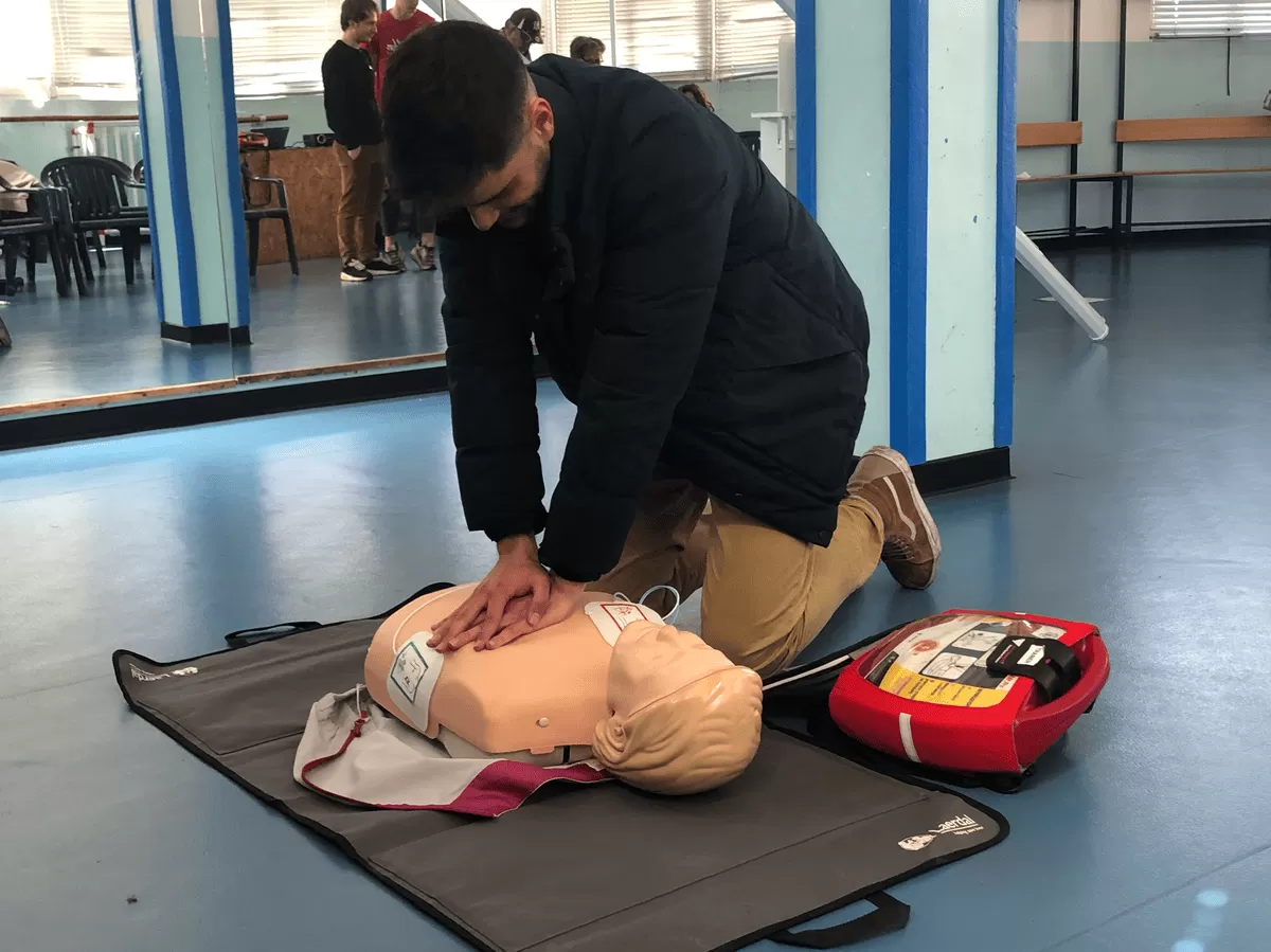 Performing CPR and following the instructions of AED