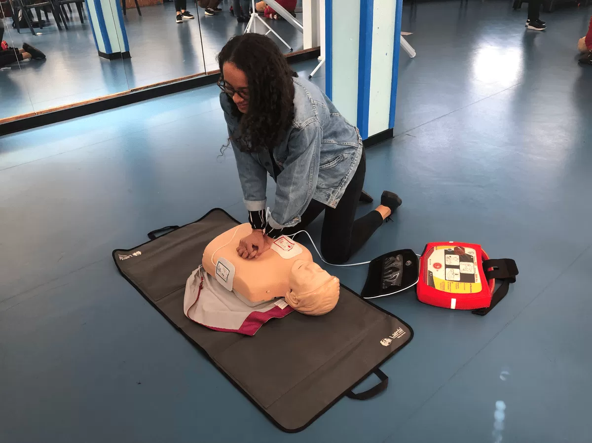 Performing CPR and following the instructions of AED