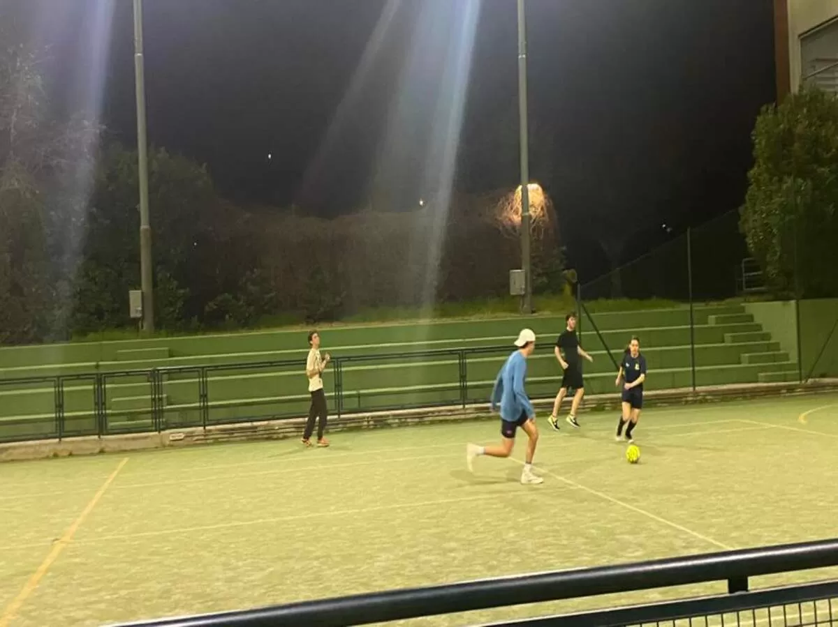 Group of international students playing five-a-side football