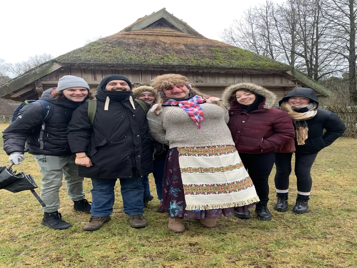 Group of students posing with one of the festivals characters