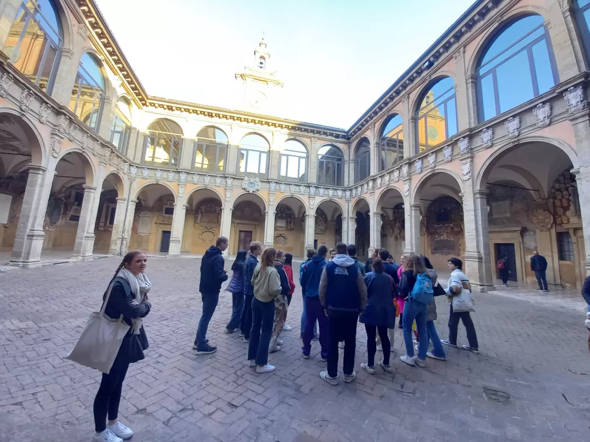 Group of internation students visiting an ancient palace in Bologna