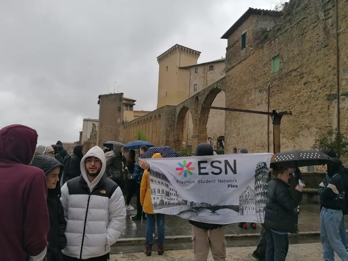 People walking in Pitigliano with ESN flag