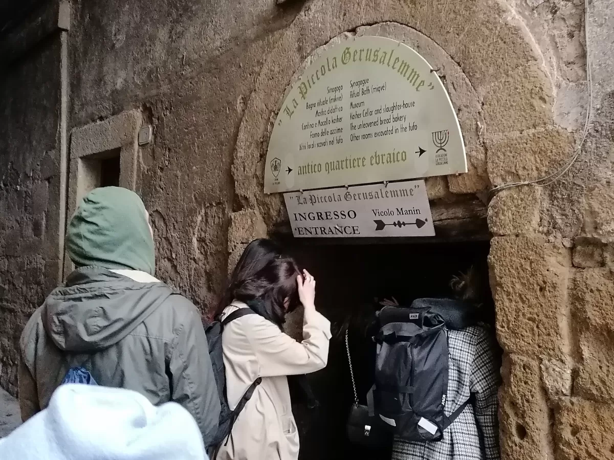 People entering a door in Pitigliano
