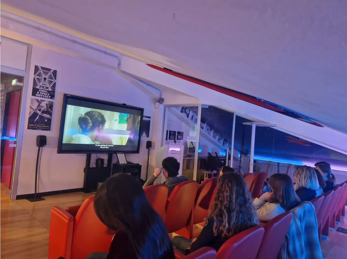 The photo shows people watching a movie