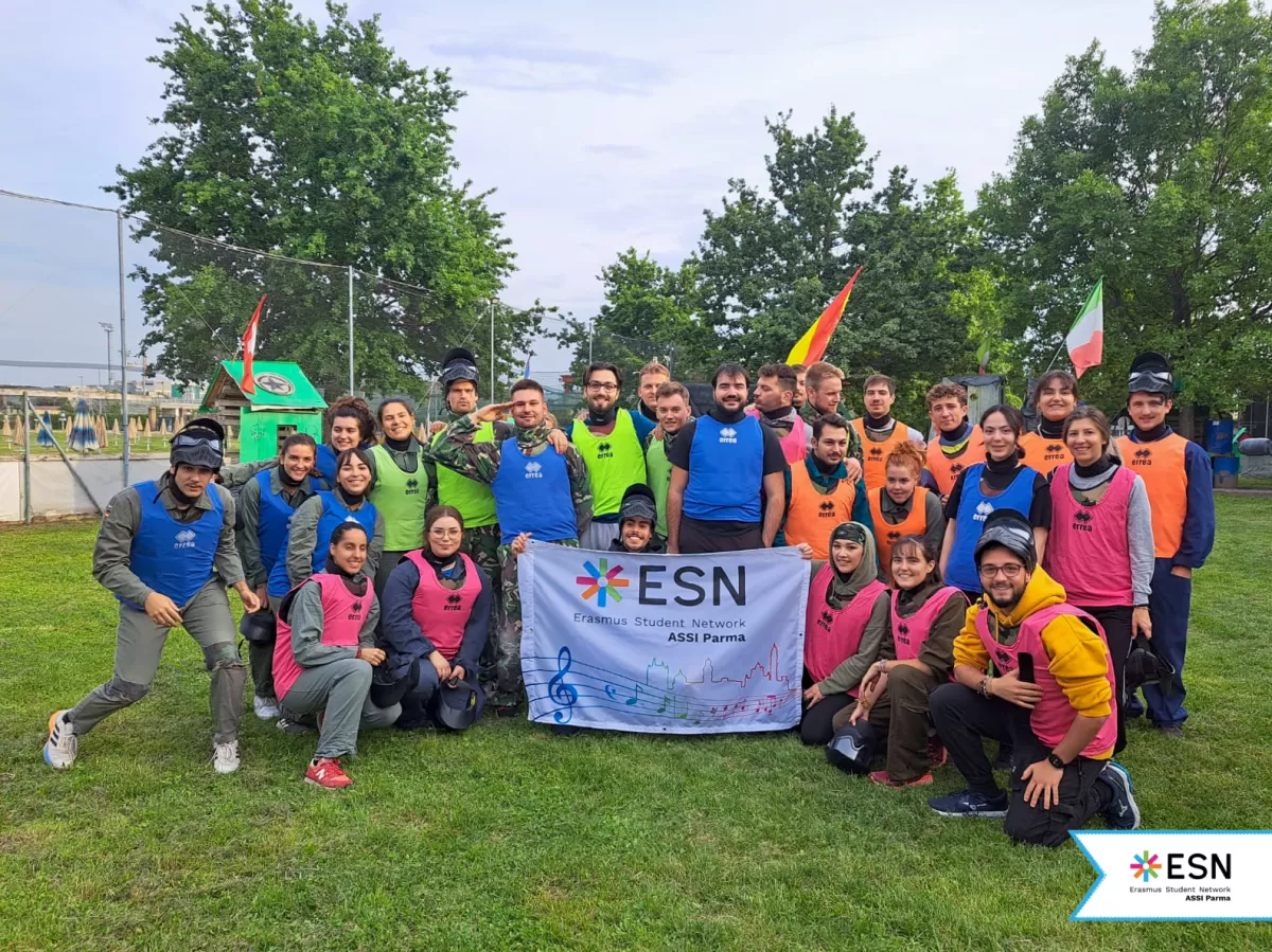 Participants posing behind the ESN ASSI Parma flag.