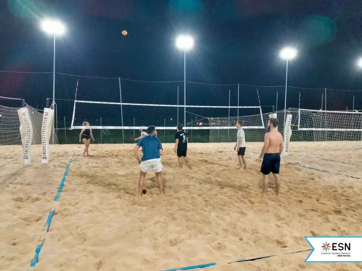 Participants playing beach volleyball together