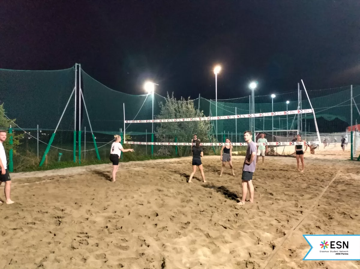 Participants playing beach volleyball together