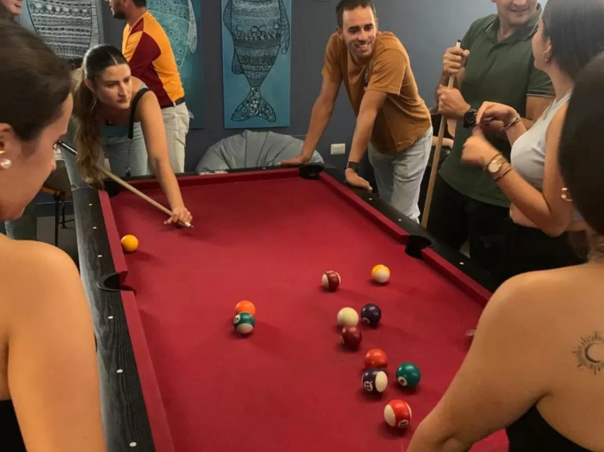Students playing together billiard