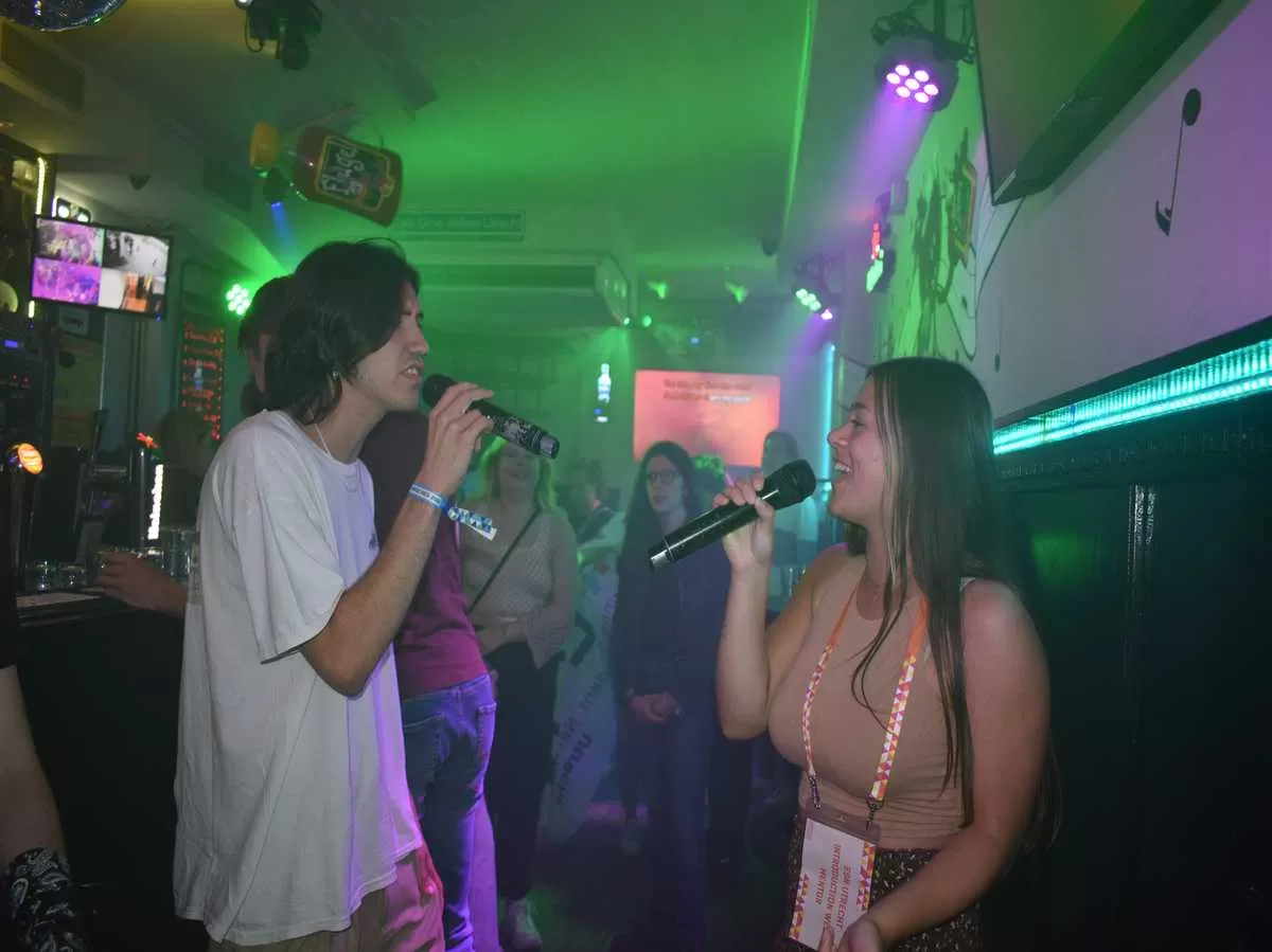 A mentor and a participant nailing a duet during the karaoke