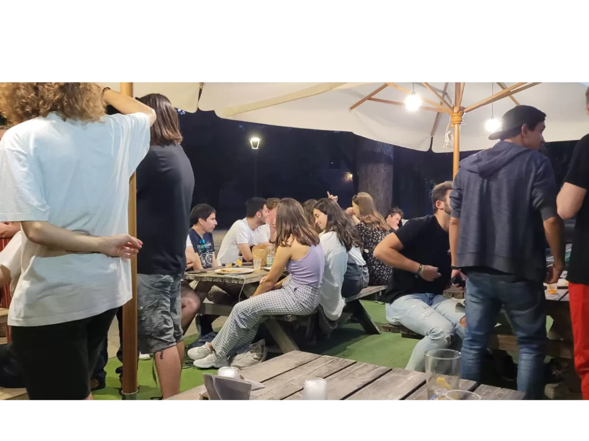 During the aperitivo, some ESNers are sit in tables while drinking and talking to each others