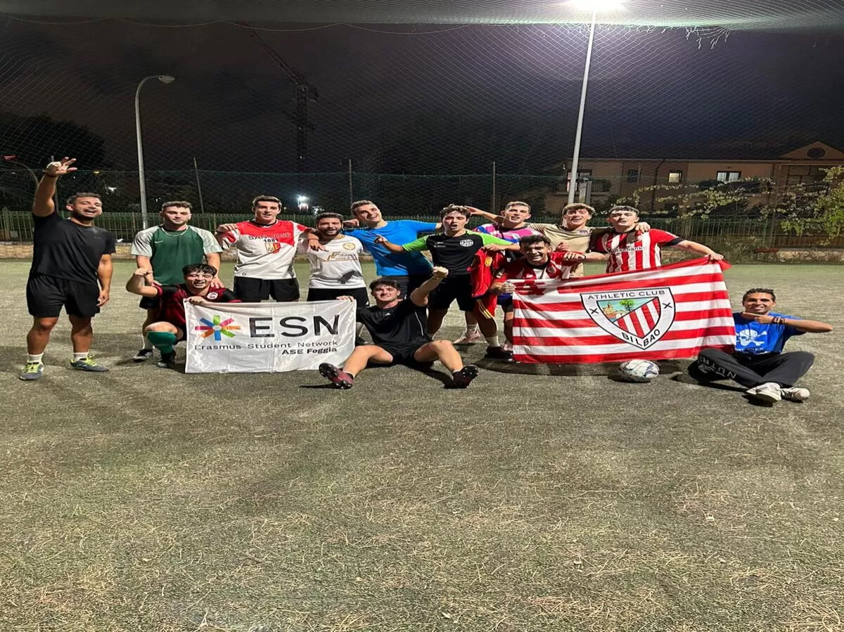 International students participating in the football match posed with the flag
