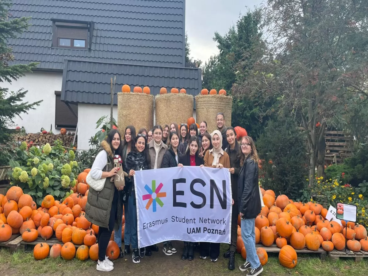 a group of international students posing in front of pumpkins