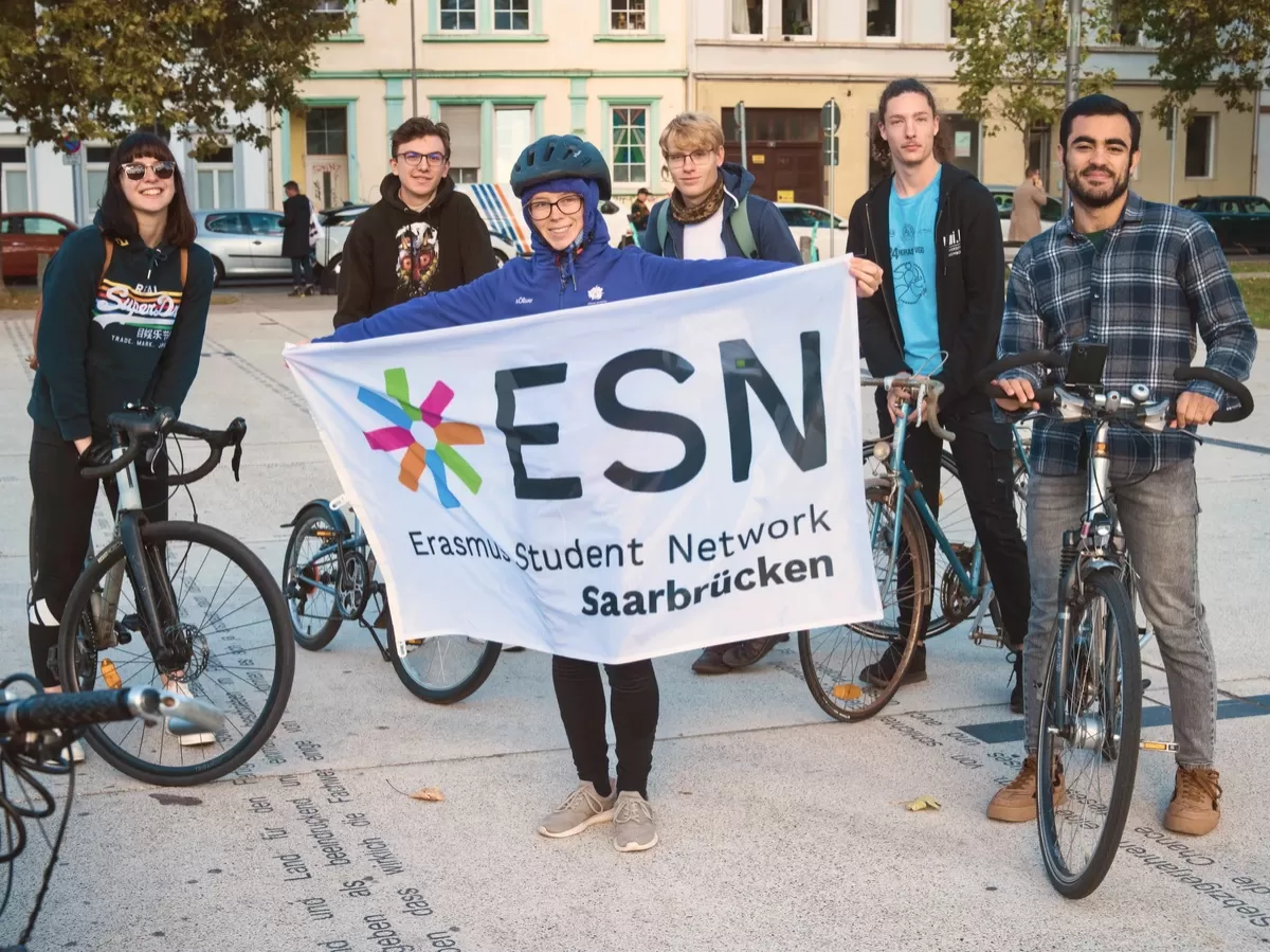 people on the bikes posing, one holding ESN flag