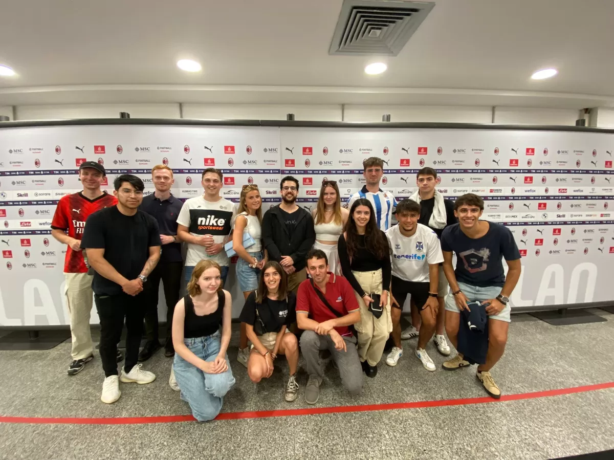 Group photo in front of the AC Milan partners logos