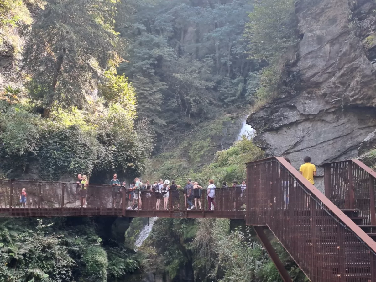 A bridge and the mountain landscape with the group walking.