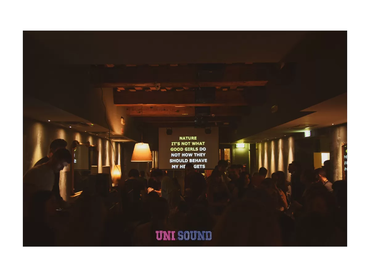 A song projected in the main room of Gingini Disco Lounge