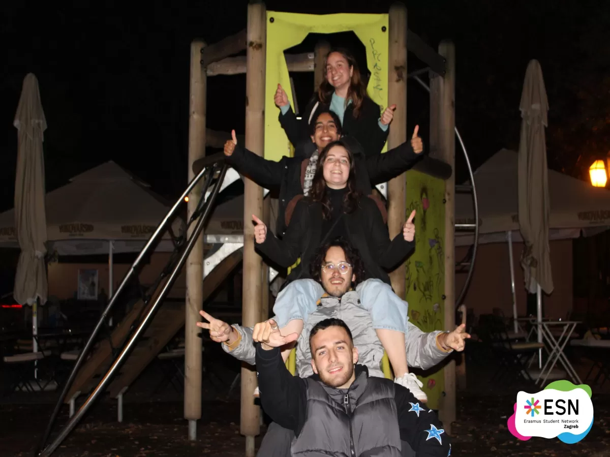 A group of people sitting on a slide.