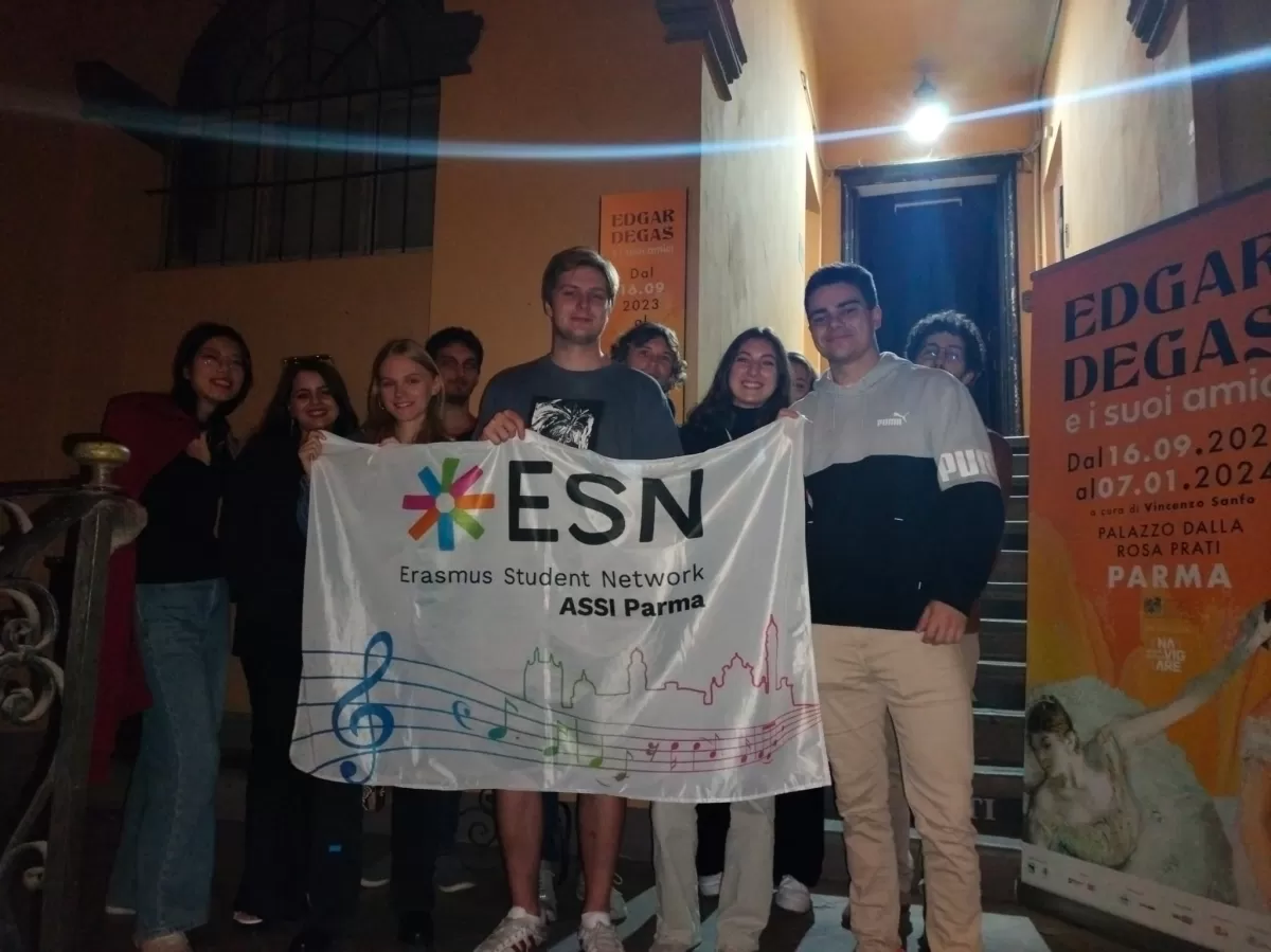 group of Erasmus students posing with our flag