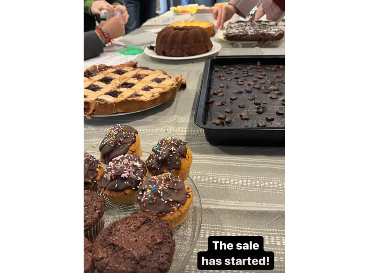 Post in our Instagram story advertising the ongoing Charity Baking Sale with a picture of some nice cakes at the booth