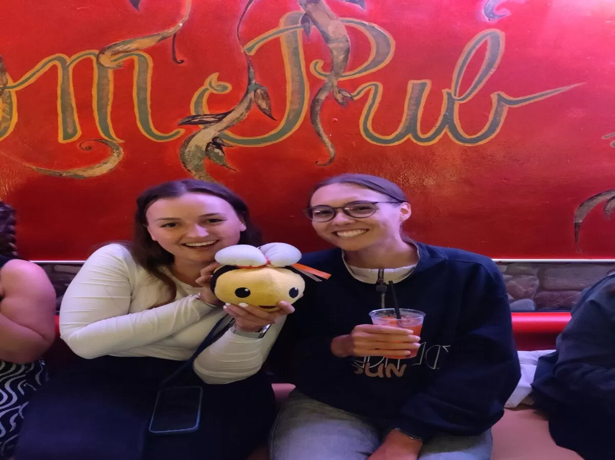 Two international students with our mascot