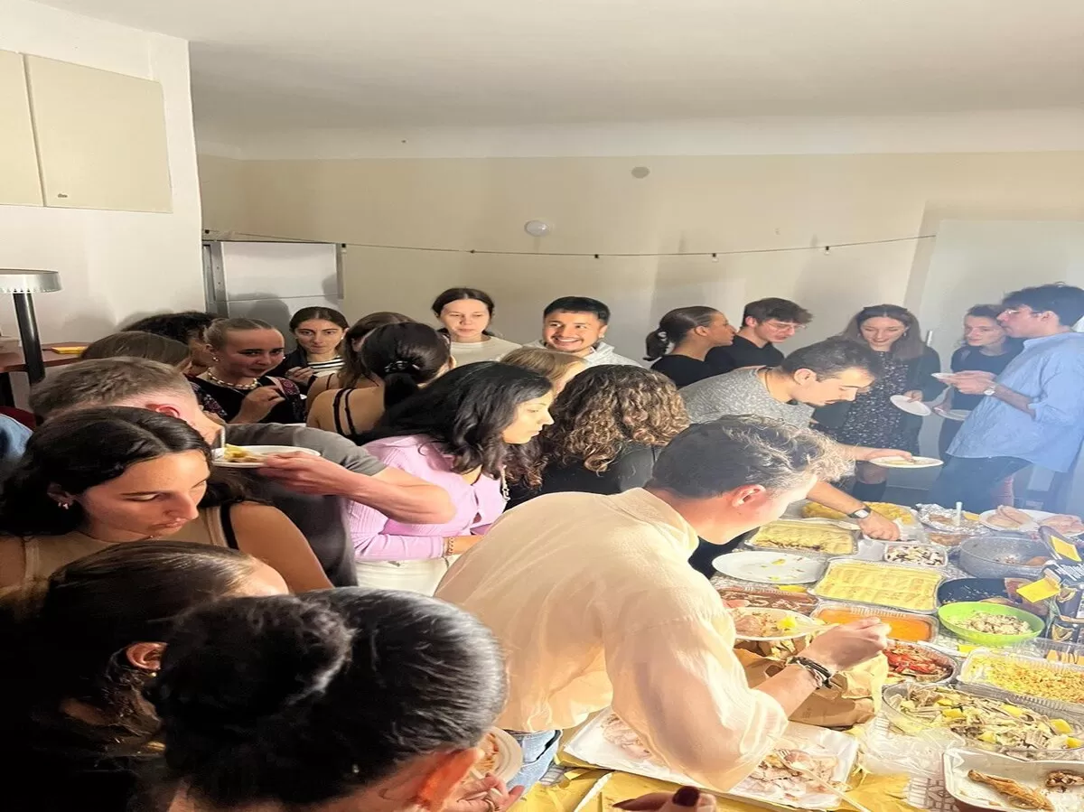 A group of international students are eating together