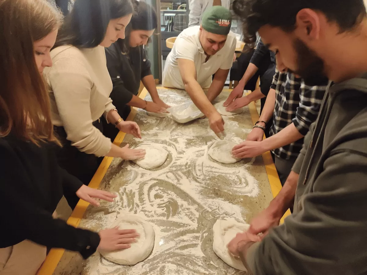 people kneading the pizza dough
