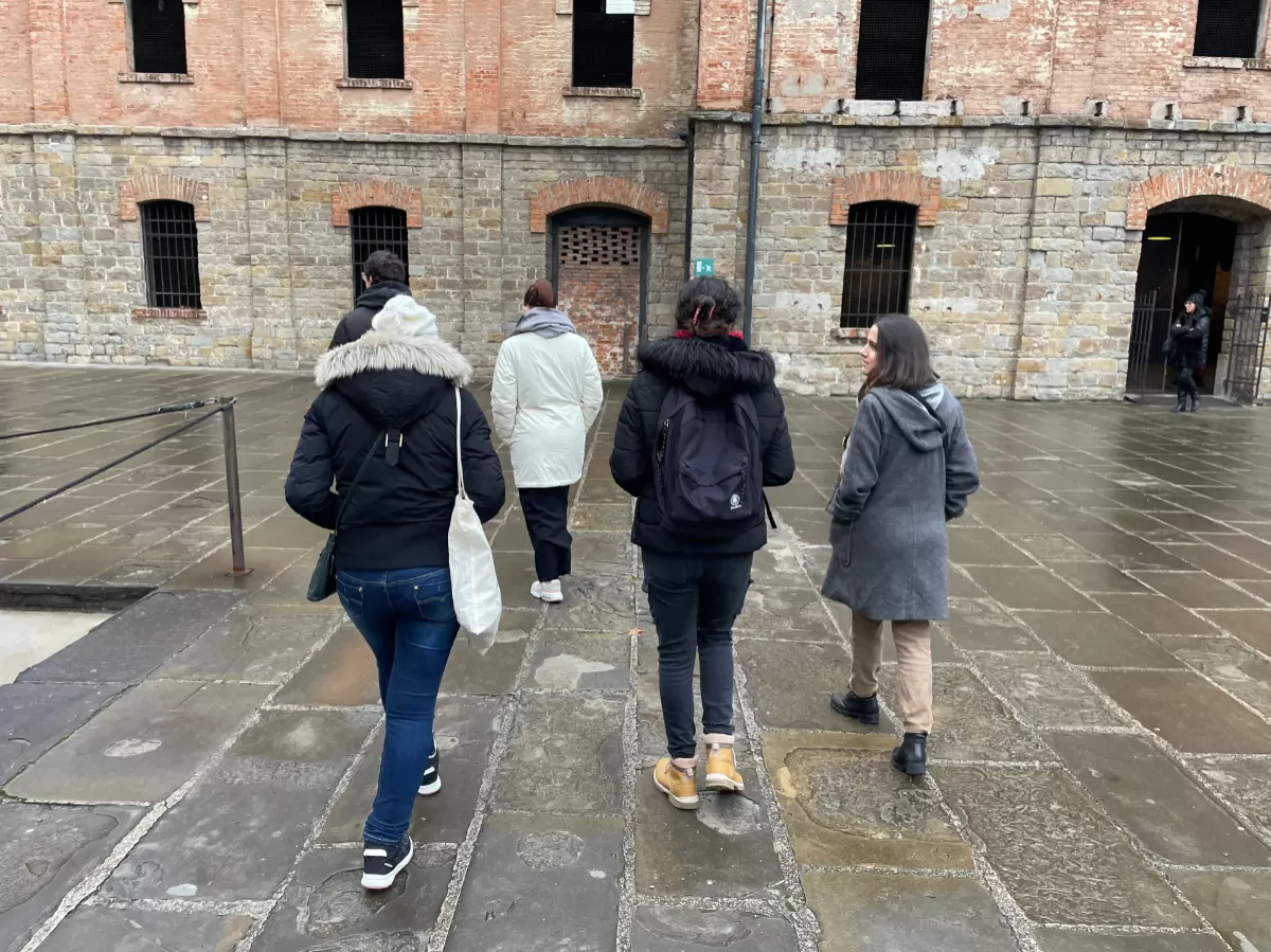 Four participants walking in the courtyard of the Rice Mill