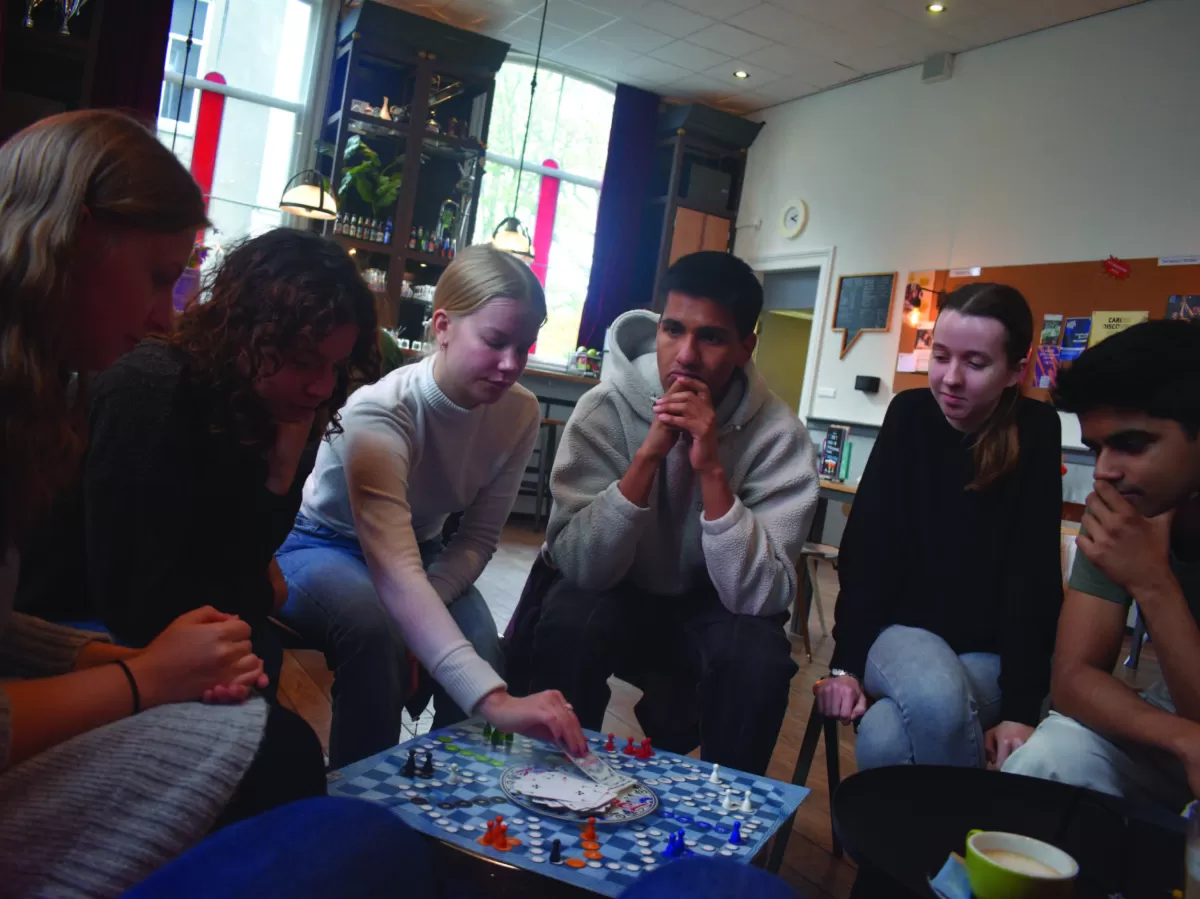 The group playing a Dutch board game