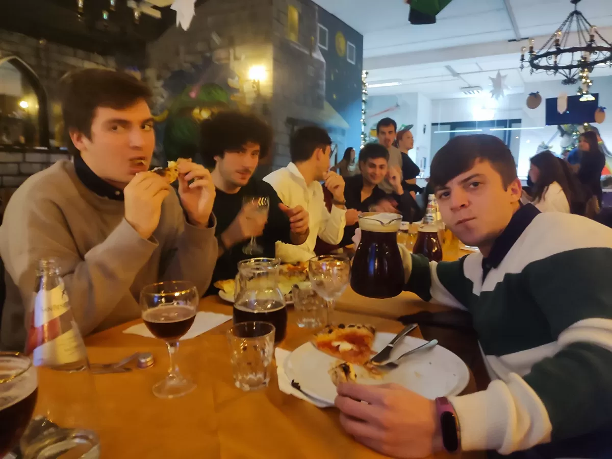 people eating and drinking at the table