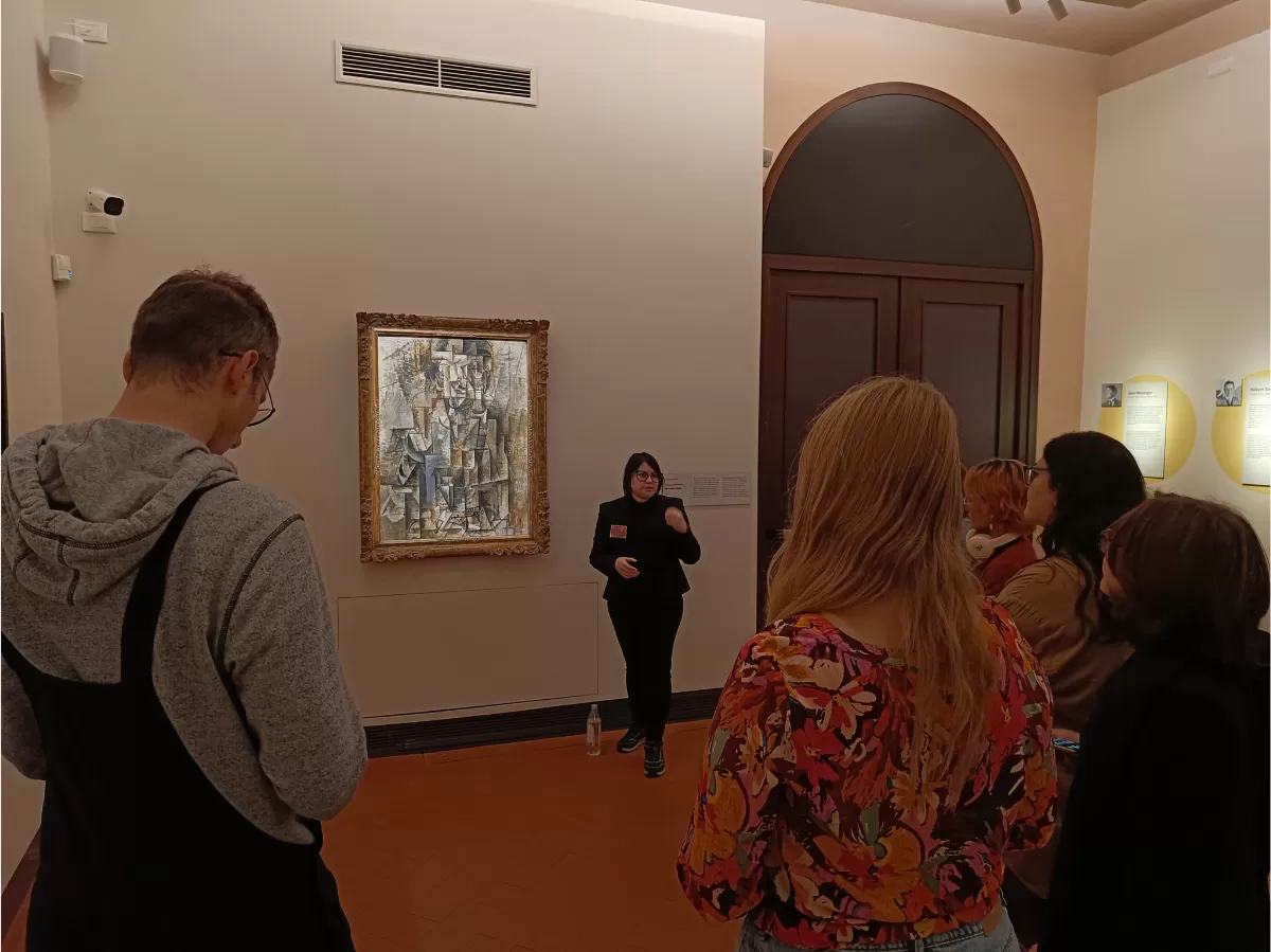 The guide is explaining a Pablo Picasso's cubist period masterpiece