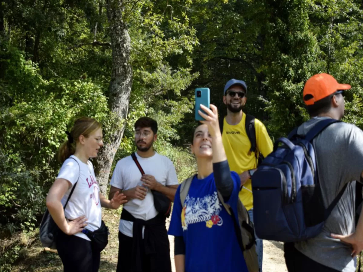 volunteers and Erasmus students walking through the wood
