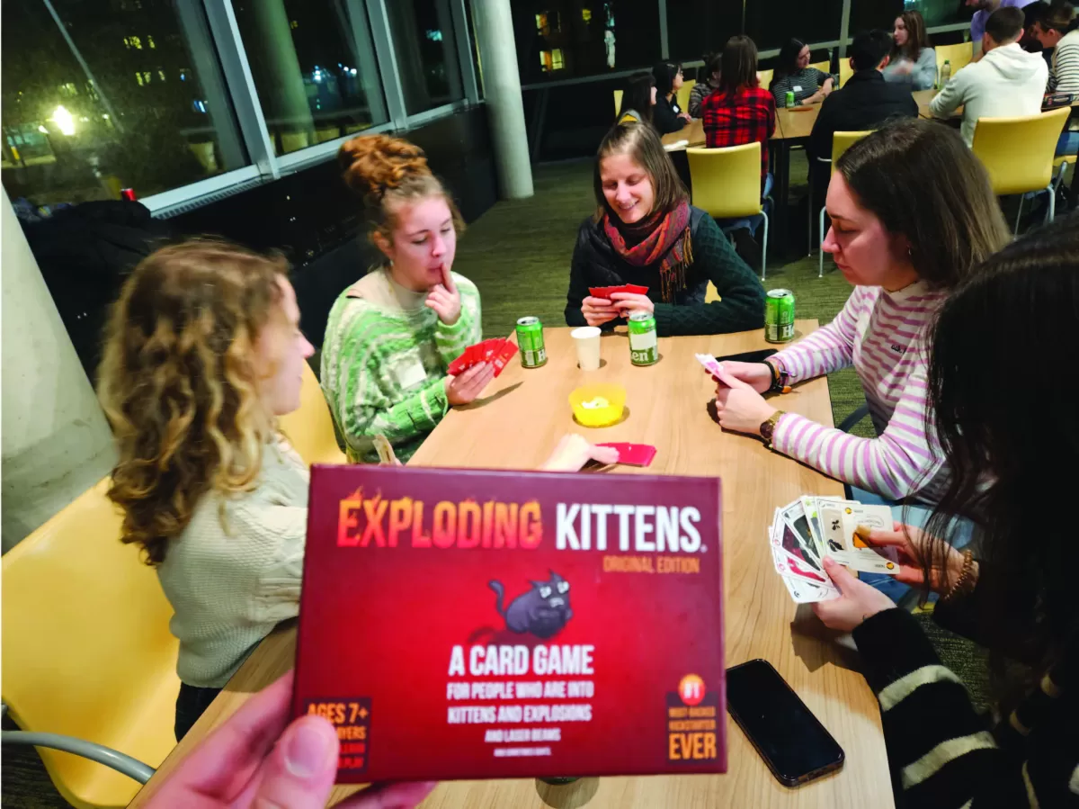 Some participants playing Exploding Kittens