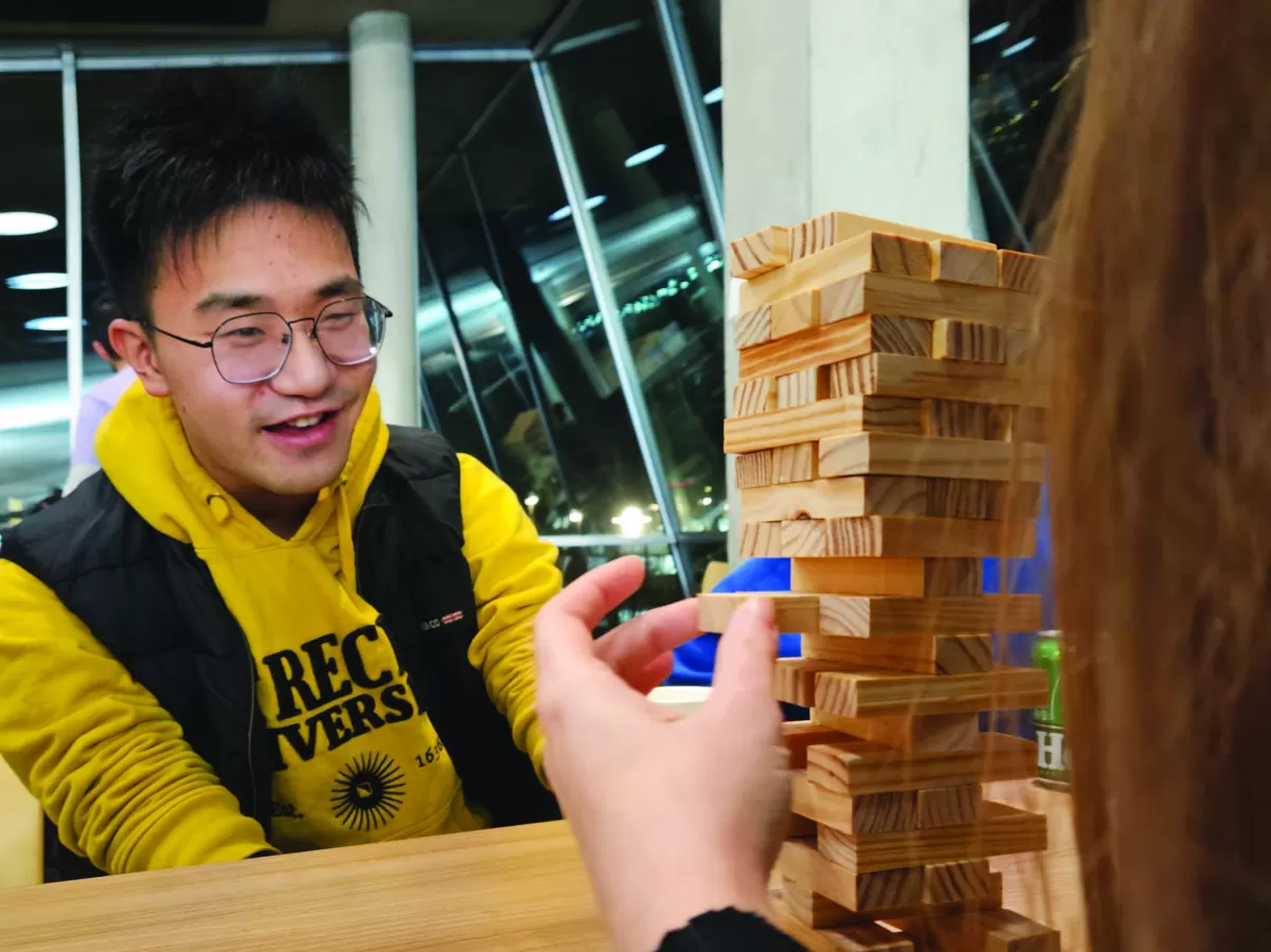 two participants playing a game of jenga