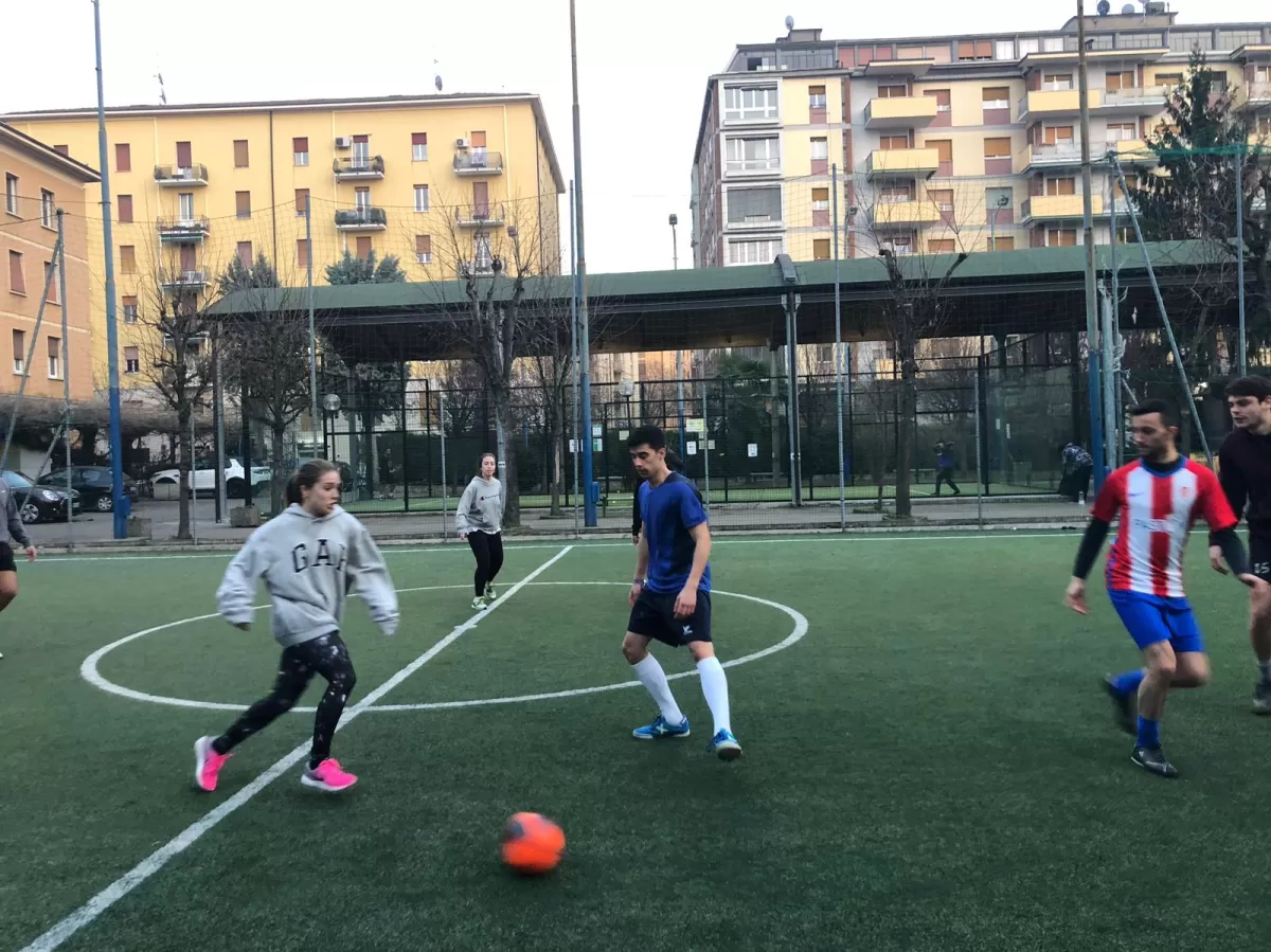 Group of international students playing futsal on a futsal pitch